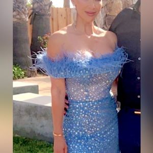 Sparkly formal dress with high slit. Amazing yeah. Off the shoulder w/feathers.